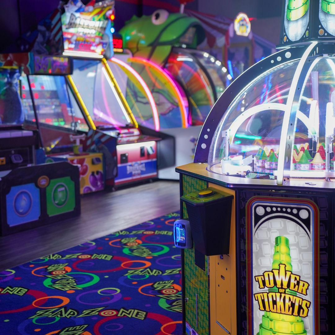 Arcade machine where you slide bundles of tickets into a slot.